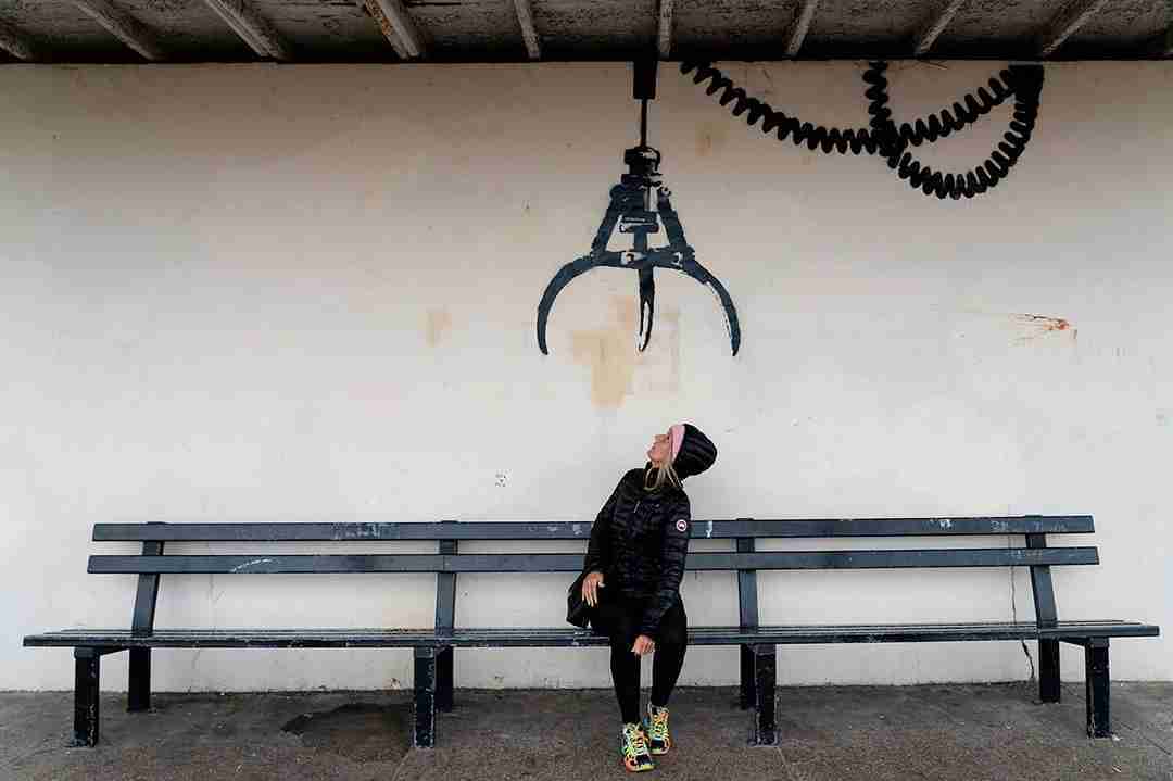 Arcade machine claw. Banksy. Image of graffiti in Gorleston depicting the typical play claw on top of a bench at a bus stop.