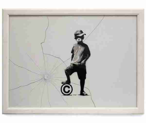 Copyright child, Banksy. Image of a boy wearing a cap stepping on a ball with the c in Copyright.