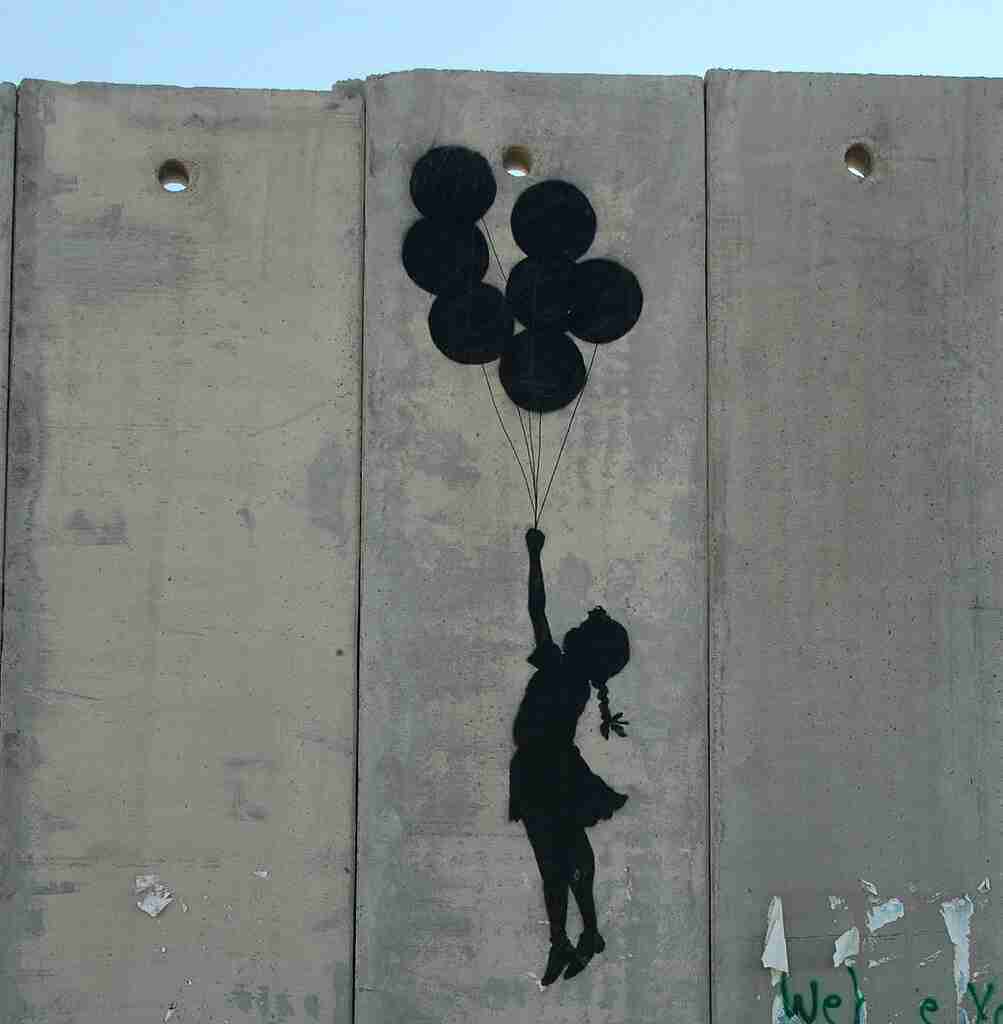 Flying balloon girl. Banksy's work on the West Bank wall depicting a girl flying with balloons.