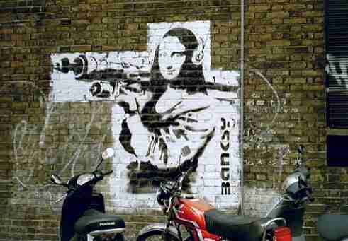 Image by Mona Lisa with Bazooka, Banksy. With helmets on a wall in Soho, London.