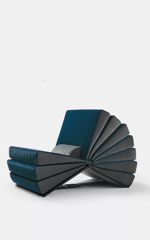 Book armchair, Busnelli. Image of the iconic 70s armchair upholstered in black and turquoise velvet. Design by Gianni Pareschi.  