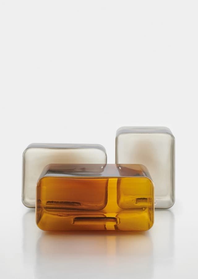 Lokum, 3 glass side tables. Real installation image, amber and smoky gray colors. 